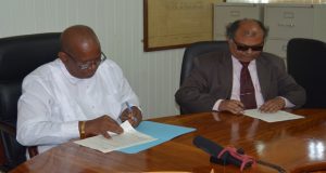 Minister of Finance, Winston Jordan and Fedders Lloyd representative, Ajay Jha signing the MOU on Tuesday 