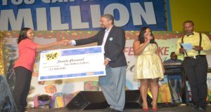 Winner of the Courts’ ‘What would you do with $1M’, Fanela Persaud receives a symbolic cheque from Courts Managing Director Clyde DeHaas 