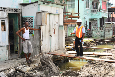 An MPI employee interacts with a resident along the affected area
