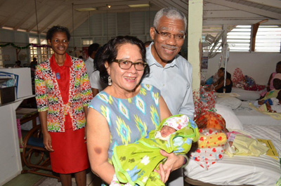 First Lady Sandra Granger still has the touch. She is pictured here holding a little girl born to Cassie Baksh of Herstelling on December 23, as President David Granger looks on.  The Grangers toured the maternity ward of the Georgetown Public Hospital on Christmas Morning