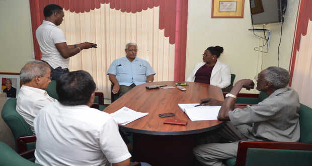 Ministers of Agriculture and Social Protection, Noel Holder and Simona Broomes respectively, speaking with GAWU President Komal Chand and General Secretary Seepaul Narine