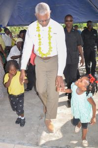 Two children escort President David Granger when he arrived at Sandvoort (Delano Williams Photo)