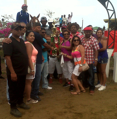 Representatives of Shariff Stable collect the winning trophy for Precise Gold’s victory in the E and Lower race.
