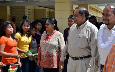 Prime Minister Moses Nagamootoo is greeted by students of the Anna Regina Multilateral School, soon after he arrived there for the meeting yesterday