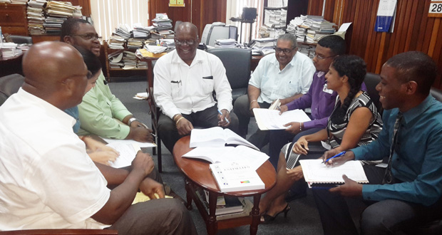 Finance Minister, Winston Jordan briefs his staff for one final time before this afternoon’s presentation of the national budget [Cullen Bess-Nelson photo)