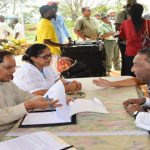 The Prime Minister takes notes as he and Mrs Nagamootoo listen to the concerns of residents of the Essequibo Coast 