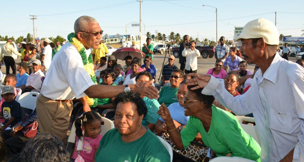 President David Granger greeting a resident of Pomeroon-Supenaam during his visit to Anna Regina