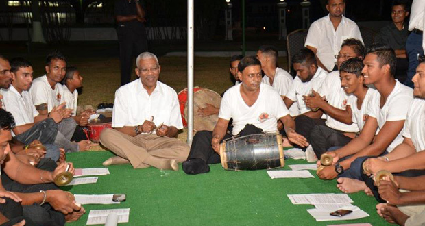 President Granger seems quite at home with the 'Jhal' or hand cymbals, an instrument that creates the high-energy rhythm synonymous with Chowtal singing [Photo by Cullen Bess-Nelson)