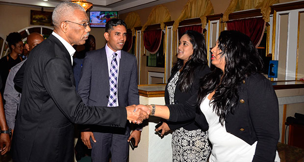 President David Granger greeting members of the executive of the Guyana Press Association: [from right) Fareeza Haniff, Nazima Raghubir; and President of the Association, Neil Marks