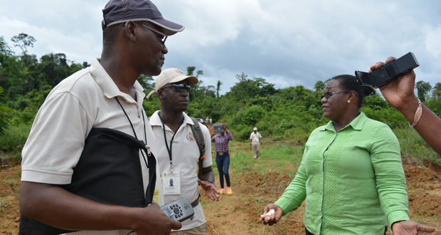 Minister Broomes speaks with GGMC officials during a trip to Konawaruk on Saturday