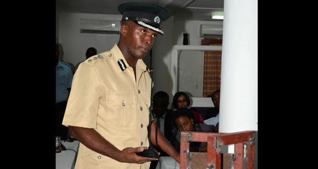 Deputy Director of Prisons, Gladwin Samuels, demonstrating to the Commission how easy it is to open the door of any division under normal conditions