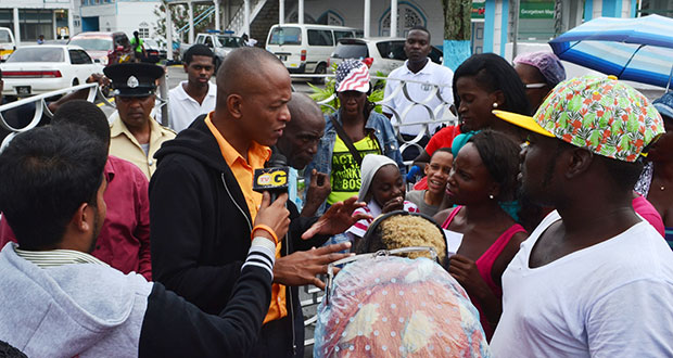 Deputy Mayor Sherod Duncan engages the peeved Stabroek Market vendors outside City Hall yesterday afternoon