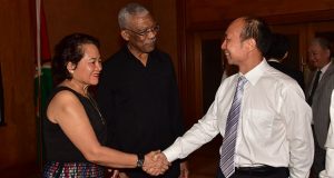 President David Granger observes as First Lady Sandra Granger greets the Head of the Chinese Medical Brigade, Dr Wang Yongxiang 