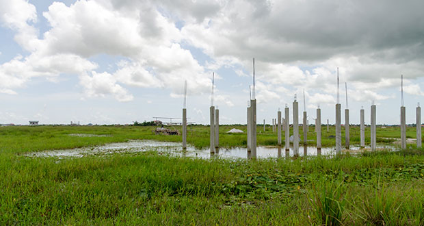 Construction of this house at Covent Garden has been put on hold because the land is presently flooded and the overflow water from the swamp is located parallel to the land