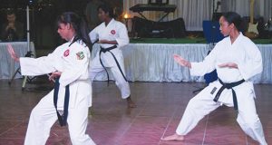 female karatekas engage in a Kata move (Stephan Sookram Photo) 