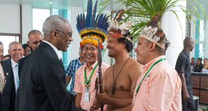 President David Granger greets several indigenous leaders, including Deputy Chairperson of the National Toshaos Council (NTC), Lennox Shuman (in traditional apparel ) and Chairman of the NTC Joel Fredericks (third from right).