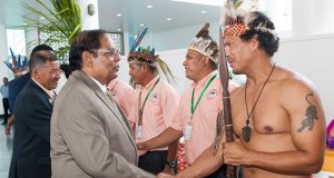 Prime Minister Moses Nagamootoo and Minister of Indigenous Peoples’ Affairs Sydney Allicock are greeted by indigenous leaders prior to the opening of the meeting of the National Toshaos Council on Monday.