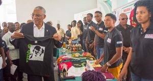My size! President Granger checks his size at one of the booths which the young entrepreneurs set-up after the graduation ceremony on Monday. 