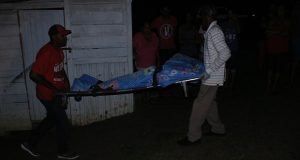 The body of 47-year old Anita ‘Sandra’ Mohan being removed from her lot 315 South East Cummings Lodge home on Sunday evening
