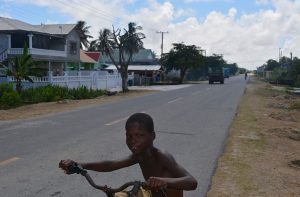 A child poses for a photograph at the side of the Dartmouth Public Road 