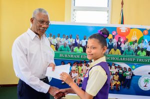President Granger making a presentation to a student of President’s College 