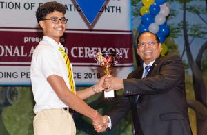 Presidential Scholarship Awardee Kayshav Tewari receives his award from Prime Minister Moses Nagamootoo, for being Guyana’s Most Outstanding Performer-Overall at the National Award Ceremony for Outstanding Performance, hosted by the Ministry of Education at the National Cultural Centre (NCC) on Friday
