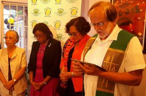  Members of the Fly Jamaica team, Minister Hughes and a religious leader engage in prayer.   