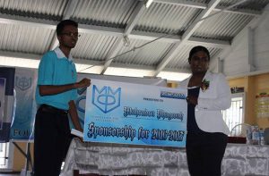 Mahendra Phagwah (left) receives the sponsorship cheque from MMP founder Mohabir Persaud