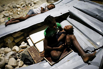 A woman cooks in an area destroyed by Hurricane Matthew in Les Anglais, Haiti. (REUTERS/Andres Martinez Casares)
