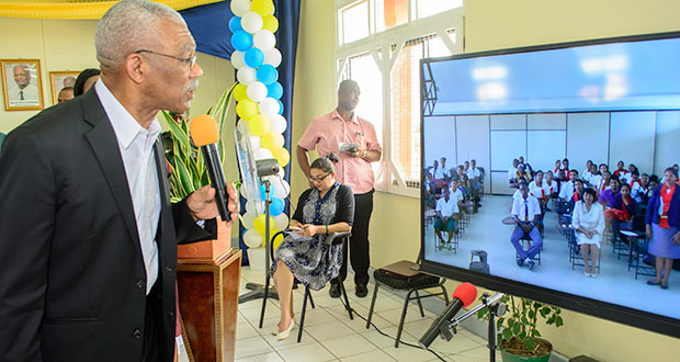 President David Granger interacts with students and teachers in Berbice who were observing the launch of the One Laptop Per Teacher Initiative which was streamed live