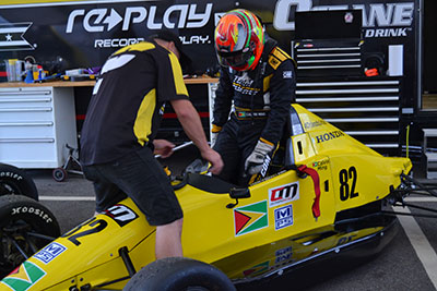 Calvin Ming being assisted into his F1600 race car for Round 20 of the Championship in Virginia. (Stephan Sookram Photo)