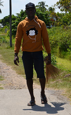 This young man said he earns a healthy sum from the rice mill. He tends to paddy along the roadway at Zambia