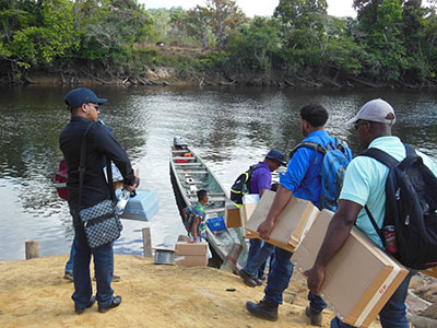 GWI officials load a boat with the filters to take to the communities