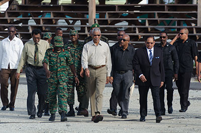 President David Granger being escorted to the D’Urban Park tarmac on Saturday morning by Chief-of-Staff of the Guyana Defence Force, Brigadier George Lewis; Prime Minister Moses Nagamootoo and Minister of Public Security, Khemraj Ramjattan 