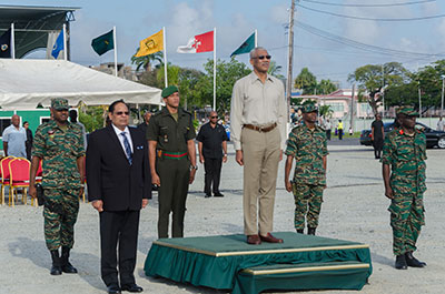President David Granger (centre); Prime Minister Moses Nagamootoo (left); and Chief-of-Staff of the GDF, Brigadier George Lewis (right), stand at attention as the National Anthem is being played (Office of the Prime Minister’s photo)