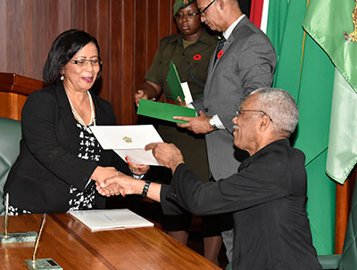 President David Granger hands over instruments of office to Mrs. Carol Corbin