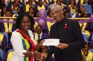 Headmistress of President’s College, Carlyn Canterbury, receiving the $1M donation from President David Granger  