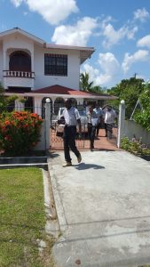 CID officers leaving the home of Clement Rohee. [Ariana Gordon photo]