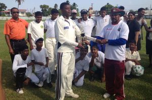 Saraswat Secondary receives the zone champions trophy from Dhanpaul(west indies trouser and hat)