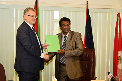 Public Security Minister, Khemraj Ramjattan and Head of the European Delegation to Guyana, Jernej Videtic shake hands after inking the MoU