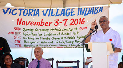 President David Granger addresses Victorians on Monday during the National Day of Villages observance. Also in the photo are (left) Minister of Public Telecommunications Catherine Hughes and Minister of Communities Ronald Bulkan (centre)