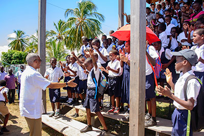 A school child is overwhelmed as President Granger extends his hands on Monday at Lady Sendall Park, Victoria, East Coast Demerara