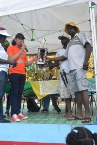 Fisherman Sarwan Kumar (in the white cap) receiving his prize for the heaviest catch 