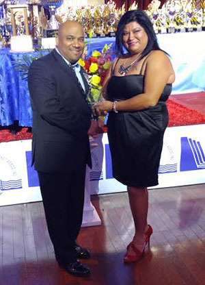 SCA secretary Eon Gunraj receives the Norman Sue Spirit Award from Kim Sue, daughter of the late businessman.