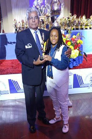 Superstars’ Lorraine Kenton receives on of her prizes from SCA’s Deo Samaroo.