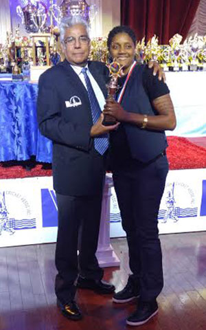 A smiling Chuntel Martin collects one of her several awards from SCA’s Deo Samaroo.