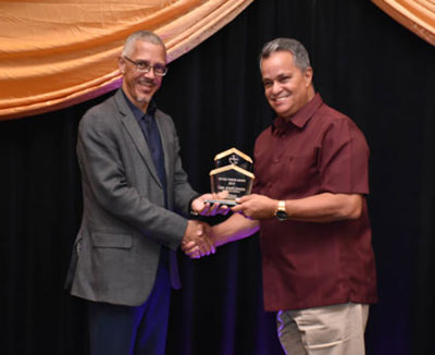 Captain Jerry Gouveia receives from Minister of Business with responsibility for Tourism, Dominic Gaskin, the award for Tourism Entrepreneur of the Year