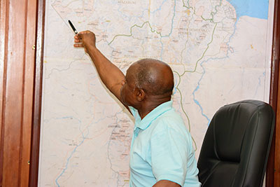 Foreign Affairs Minister Carl Greenidge points to a map of Guyana in his office as he explains the Guyana-Venezuela border controversy (on Sunday) 