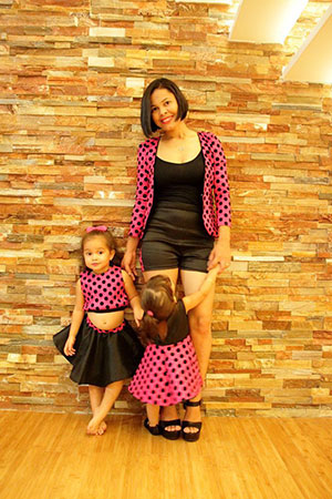 Ulynie DeNobrega and her two daughters in matching ‘Mommy and Me’ outfits from her Sandbox Designs line 