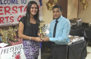 MVP Trushil Patel receives one of his several awards from female player Megan Yougnauth.